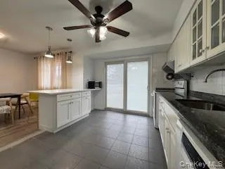 a kitchen with a cabinets and chandelier