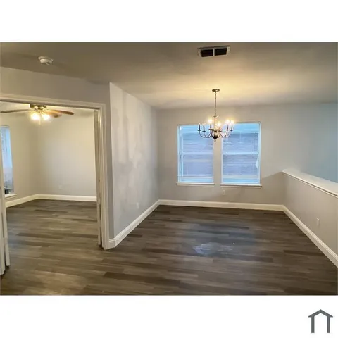 a room with wooden floor and window