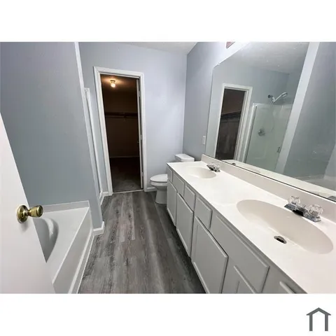 a bathroom with a sink a tub and mirror