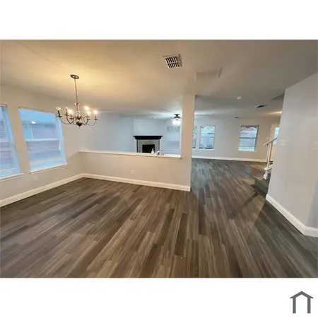a bathroom with a sink a mirror and wooden floor