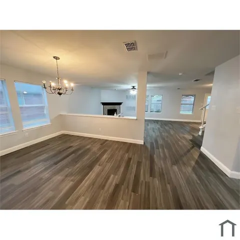 a bathroom with a sink a mirror and wooden floor