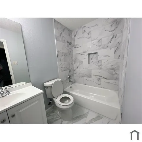 a bathroom with a sink a toilet and bathtub