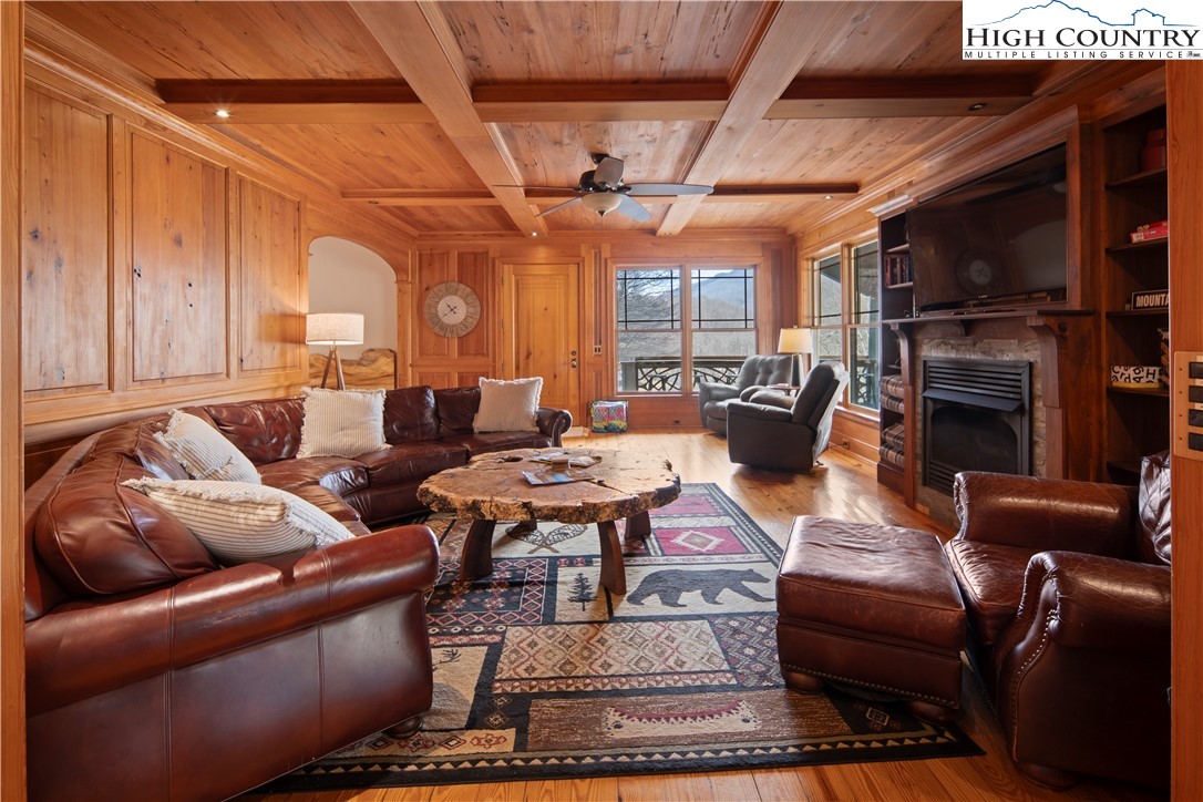 442 Aldridge Road Banner Elk, NC 28604 - Photo 12 of 50 a living room with furniture a fireplace and a ceiling fan