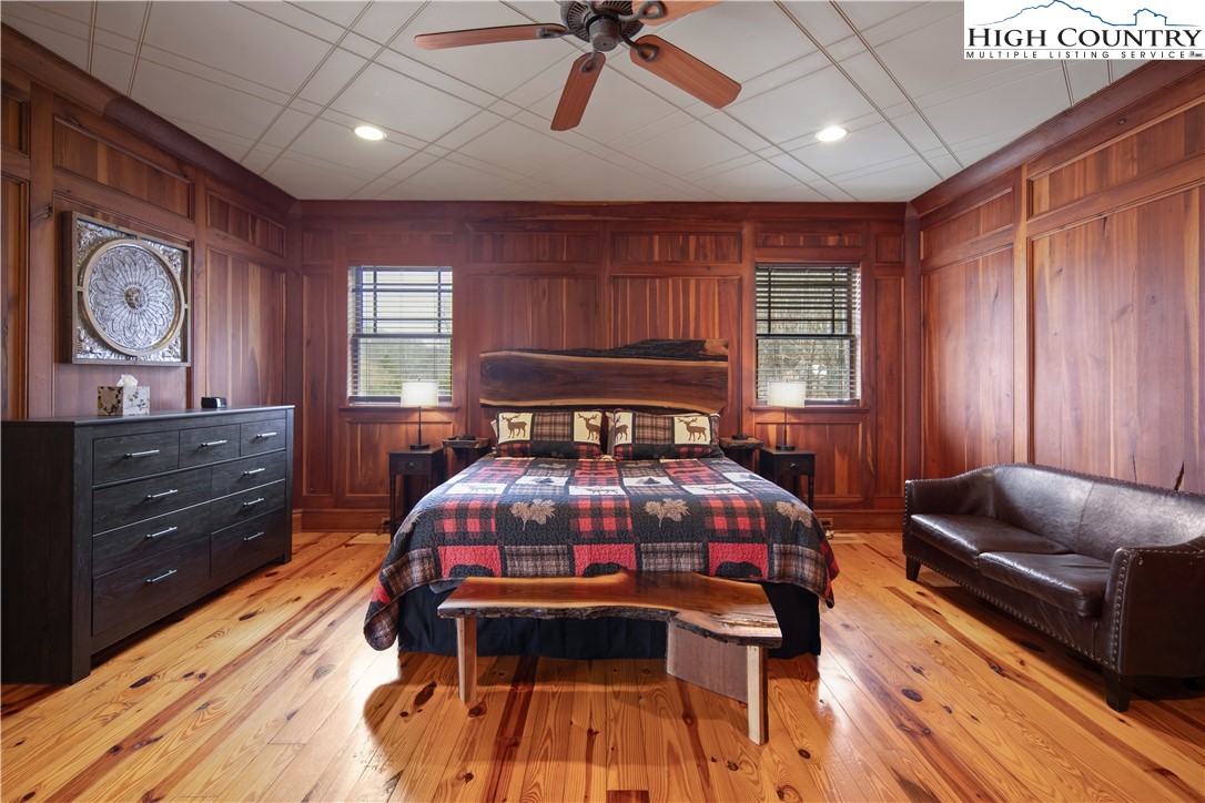 442 Aldridge Road Banner Elk, NC 28604 - Photo 15 of 50 a bedroom with a bed and wooden floor