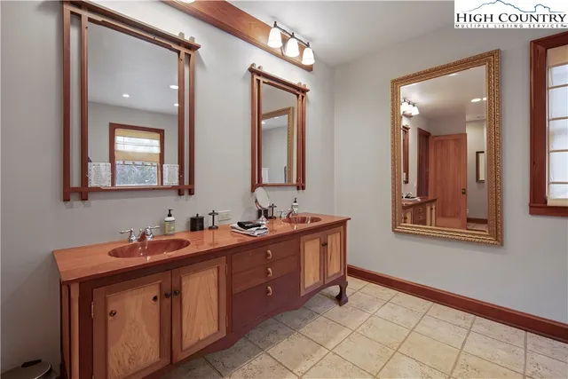 a bathroom with 2 sink and a mirror