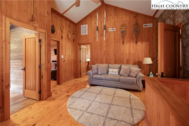 a living room with furniture a large window and a rug