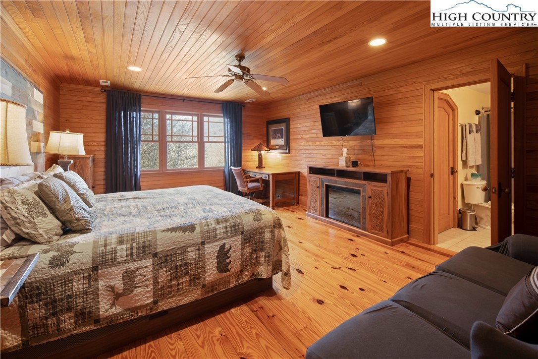 442 Aldridge Road Banner Elk, NC 28604 - Photo 22 of 50 a spacious bedroom with a bed and a flat screen tv