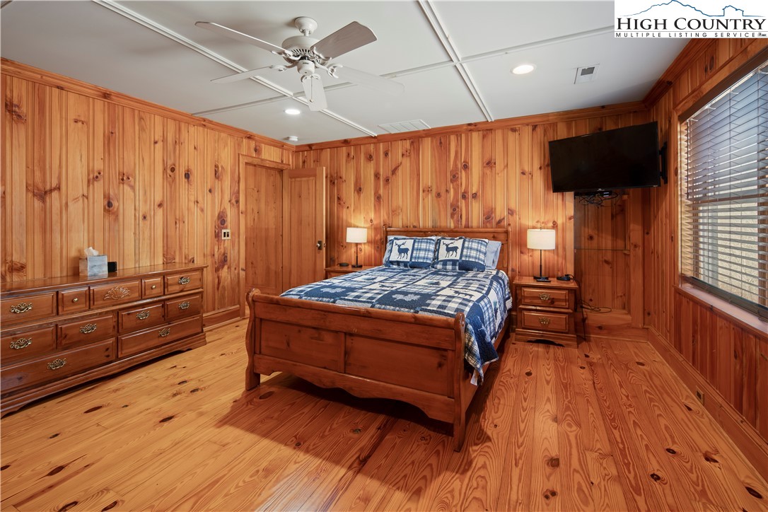 442 Aldridge Road Banner Elk, NC 28604 - Photo 23 of 50 a bedroom with a bed and a flat tv screen on dresser