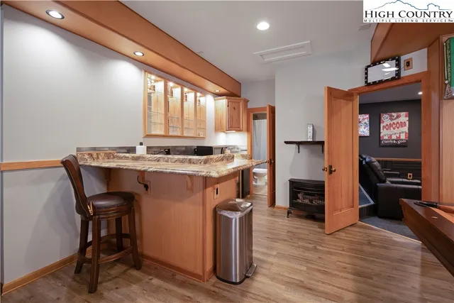 a kitchen that has a table chairs in it and wooden floors