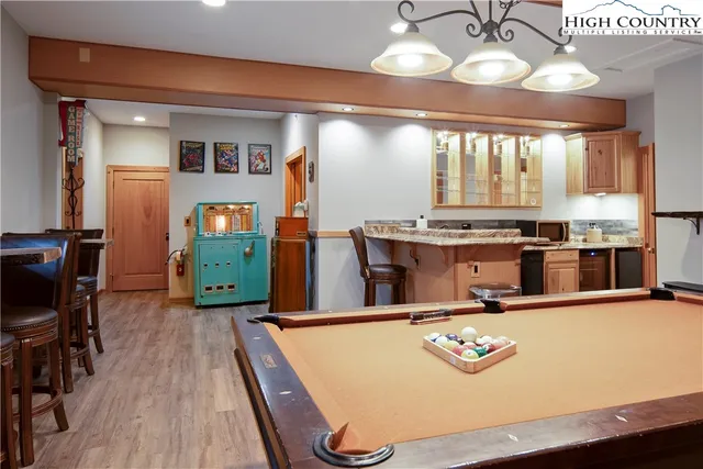 a room with stainless steel appliances kitchen island granite countertop furniture and a large window