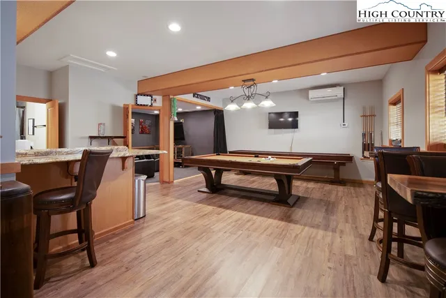 a living room with furniture a piano and a wooden floor