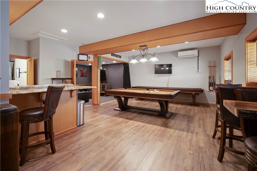 442 Aldridge Road Banner Elk, NC 28604 - Photo 34 of 50 a living room with furniture a piano and a wooden floor
