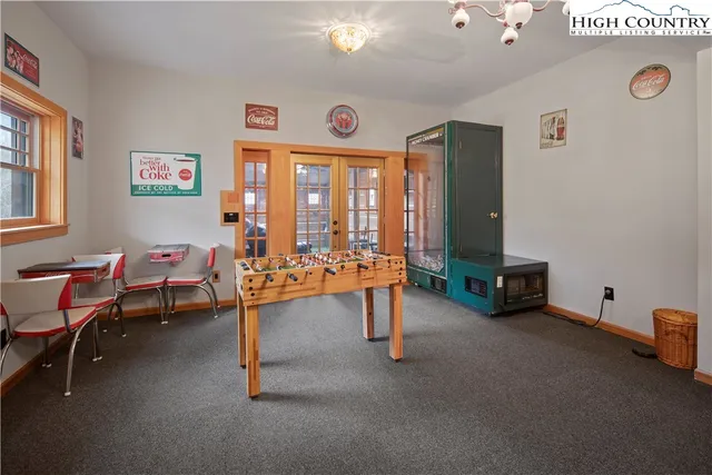 a view of a livingroom with workspace and a window