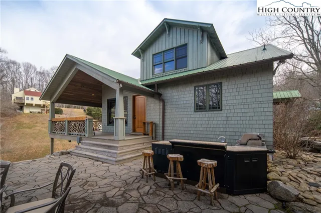 a backyard of a house with barbeque oven and table