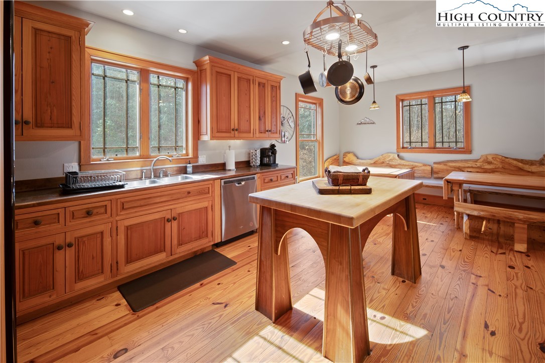 442 Aldridge Road Banner Elk, NC 28604 - Photo 9 of 50 a kitchen with stainless steel appliances granite countertop a stove a sink dishwasher and white cabinets with wooden floor