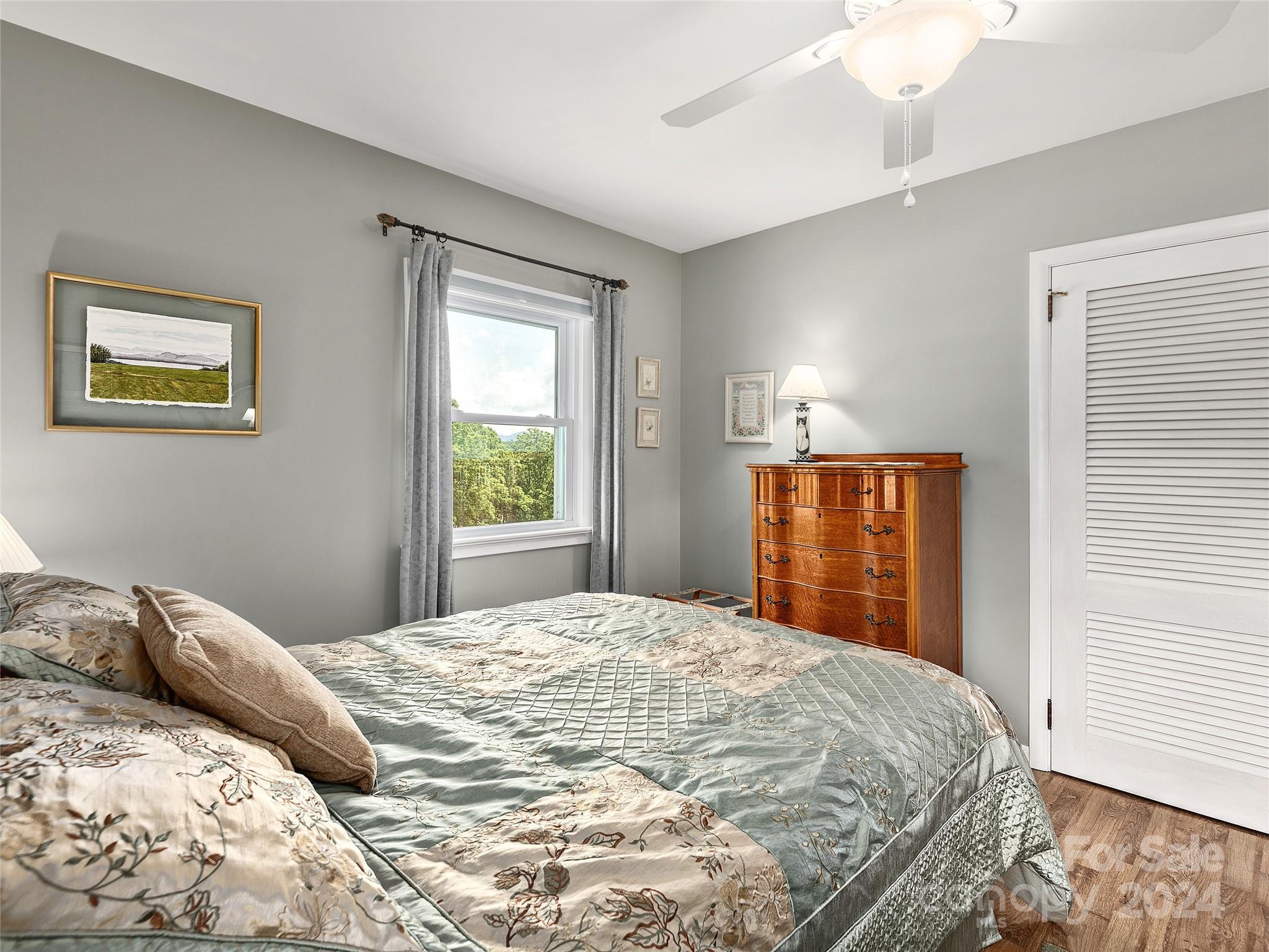 175 Rogers Street Clyde, NC 28721 - Photo 20 of 35 a bedroom with a bed and a window