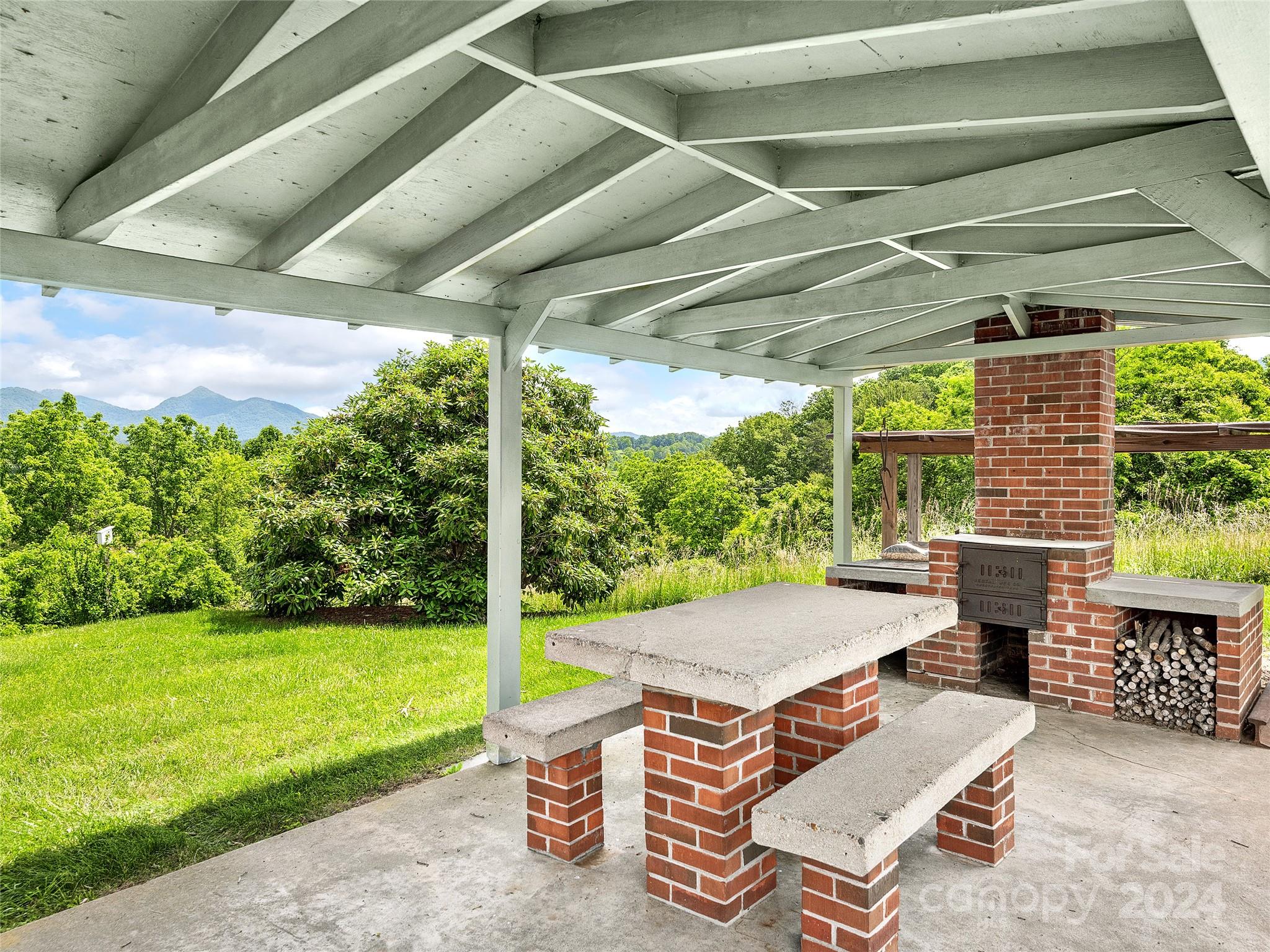 175 Rogers Street Clyde, NC 28721 - Photo 32 of 35 a backyard of a house with outdoor seating