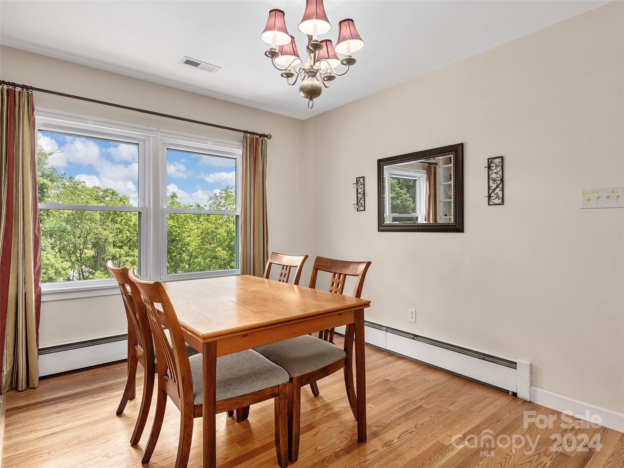 175 Rogers Street Clyde, NC 28721 - Photo 7 of 35 a view of a dining room with furniture window and wooden floor