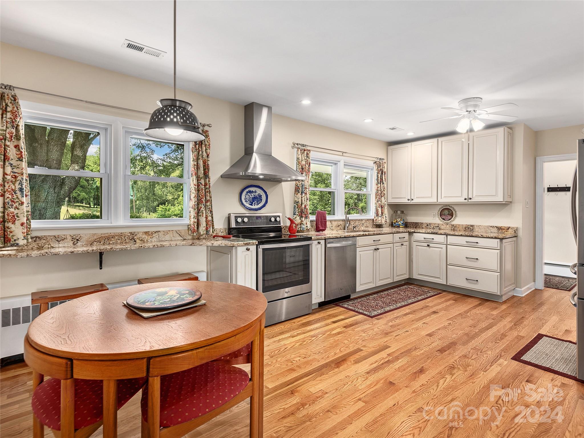 175 Rogers Street Clyde, NC 28721 - Photo 8 of 35 a kitchen with a sink a window and stainless steel appliances