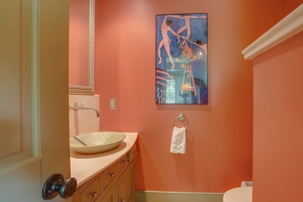 916 Chase Road Lunenburg, MA 01462 - Photo 25 of 42 a bathroom with a sink and mirror with toilet