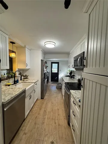 a kitchen with a sink stove and refrigerator