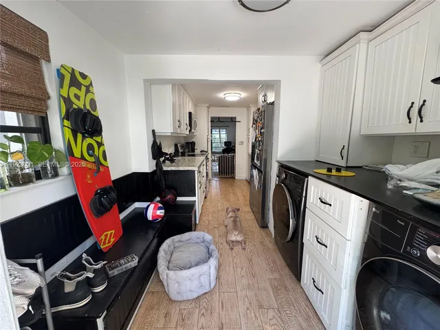 a view of a chair and table in backyard of the house