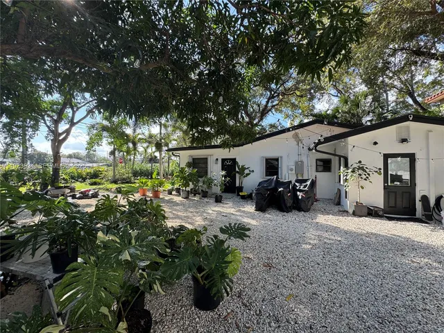a view of a house with a tree in the background