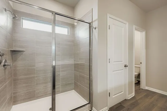 a bathroom with a glass shower door
