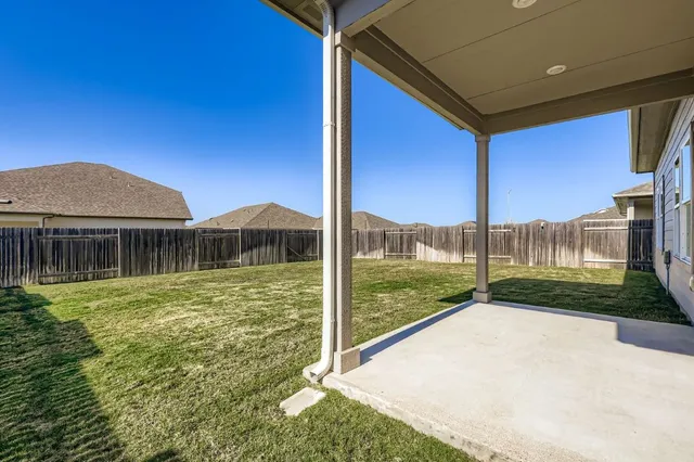 a view of a house with backyard porch and sitting area
