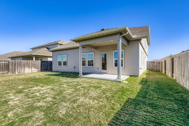 a view of a house with a backyard