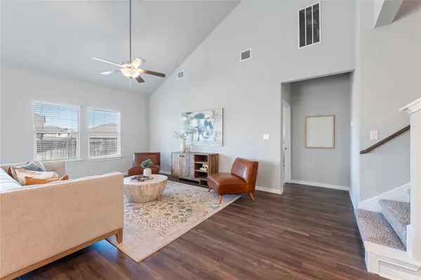 a living room with furniture and a chandelier
