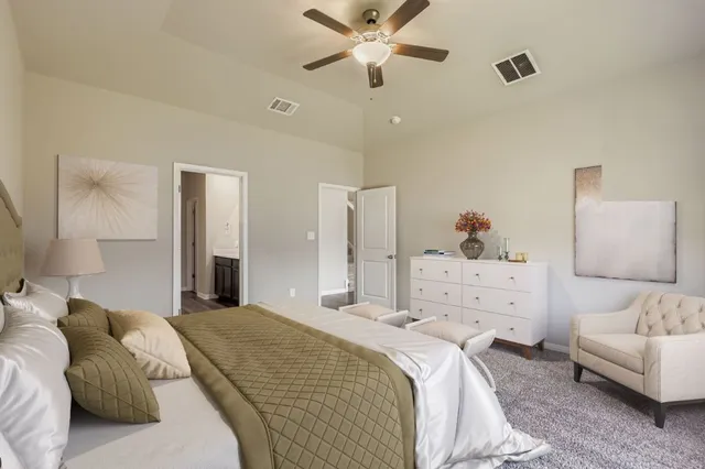 a bedroom with a bed and ceiling fan