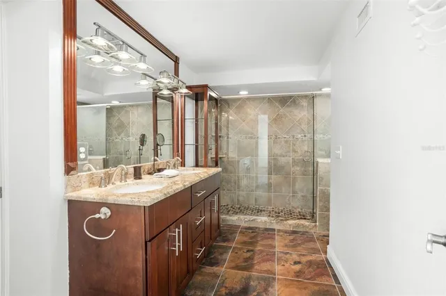 a view of a bathroom with a sink and a mirror