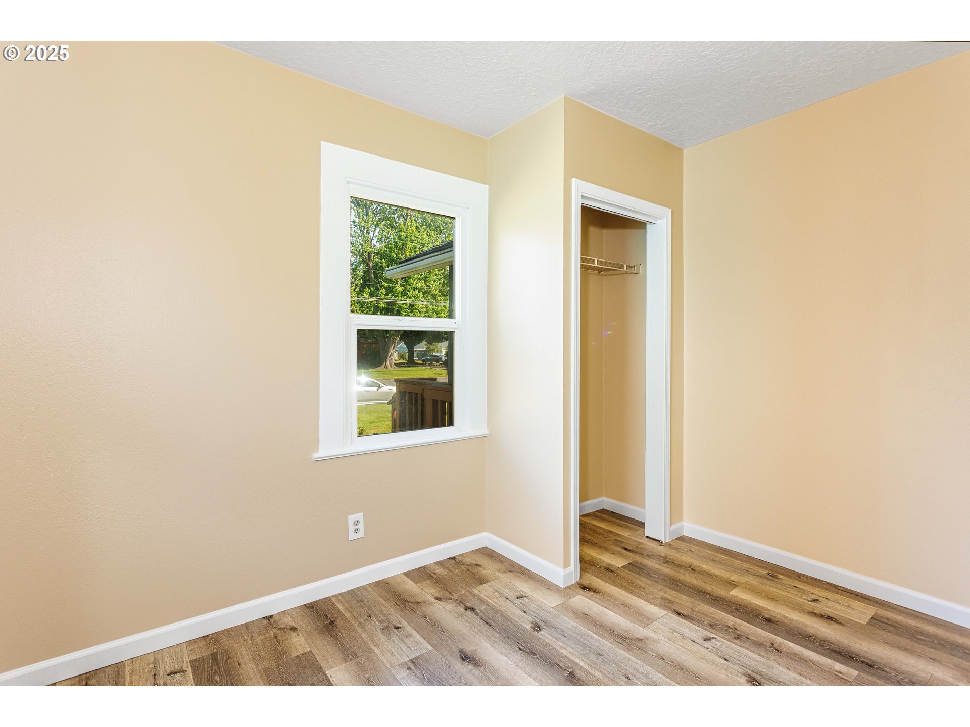 1617 7th Avenue Longview, WA 98632 - Photo 8 of 23 a view of an empty room with wooden floor and a window