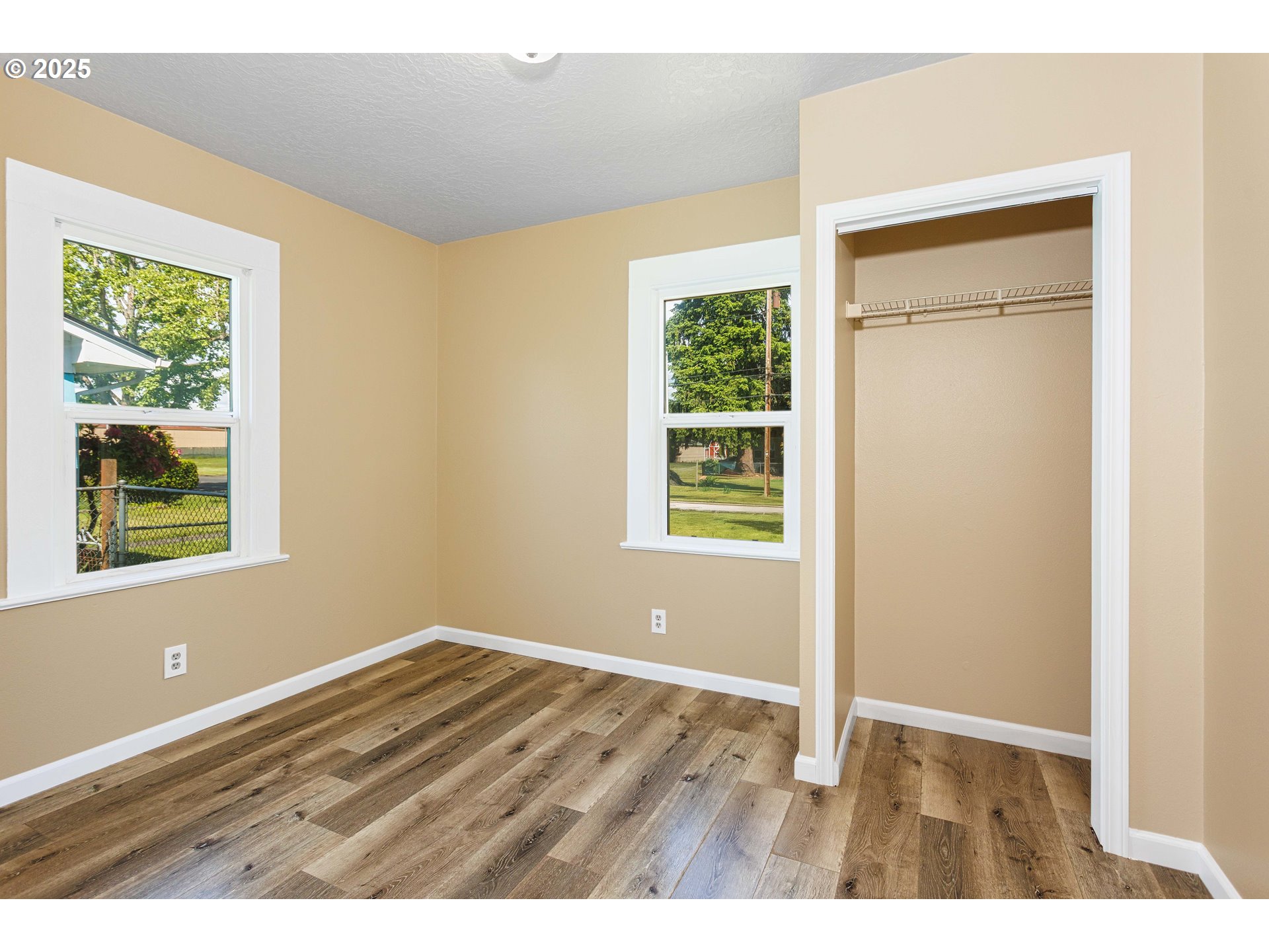 1617 7th Avenue Longview, WA 98632 - Photo 9 of 23 a view of an empty room with wooden floor and a window