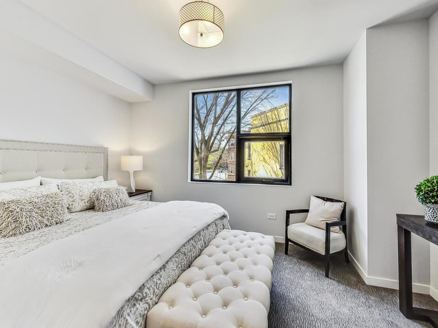 5691 North Ridge Avenue, Unit 201 Chicago, IL 60660 - Photo 15 of 31 a bedroom with a bed and a couch