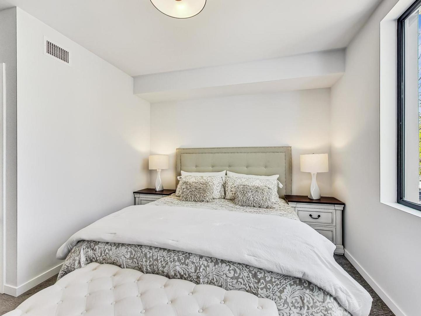 5691 North Ridge Avenue, Unit 201 Chicago, IL 60660 - Photo 16 of 31 a bedroom with a bed and a night stand