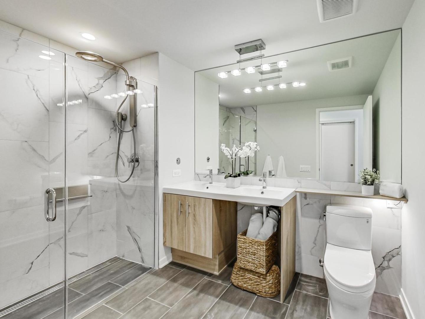 5691 North Ridge Avenue, Unit 201 Chicago, IL 60660 - Photo 21 of 31 a bathroom with a sink toilet and shower