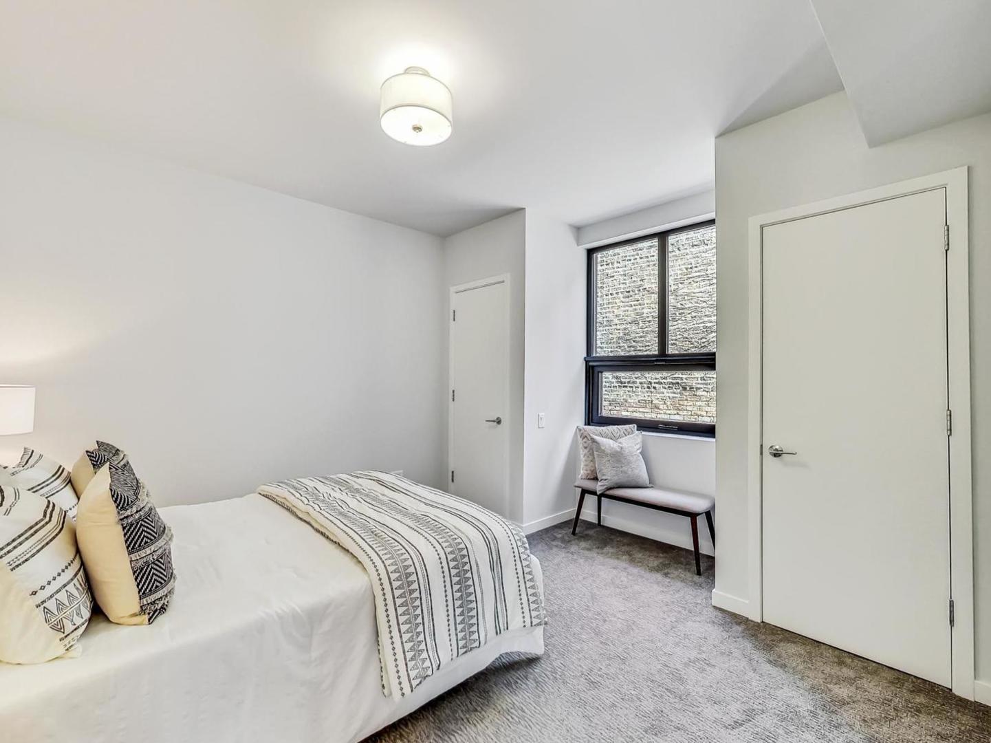 5691 North Ridge Avenue, Unit 201 Chicago, IL 60660 - Photo 22 of 31 a bedroom with a bed and a window