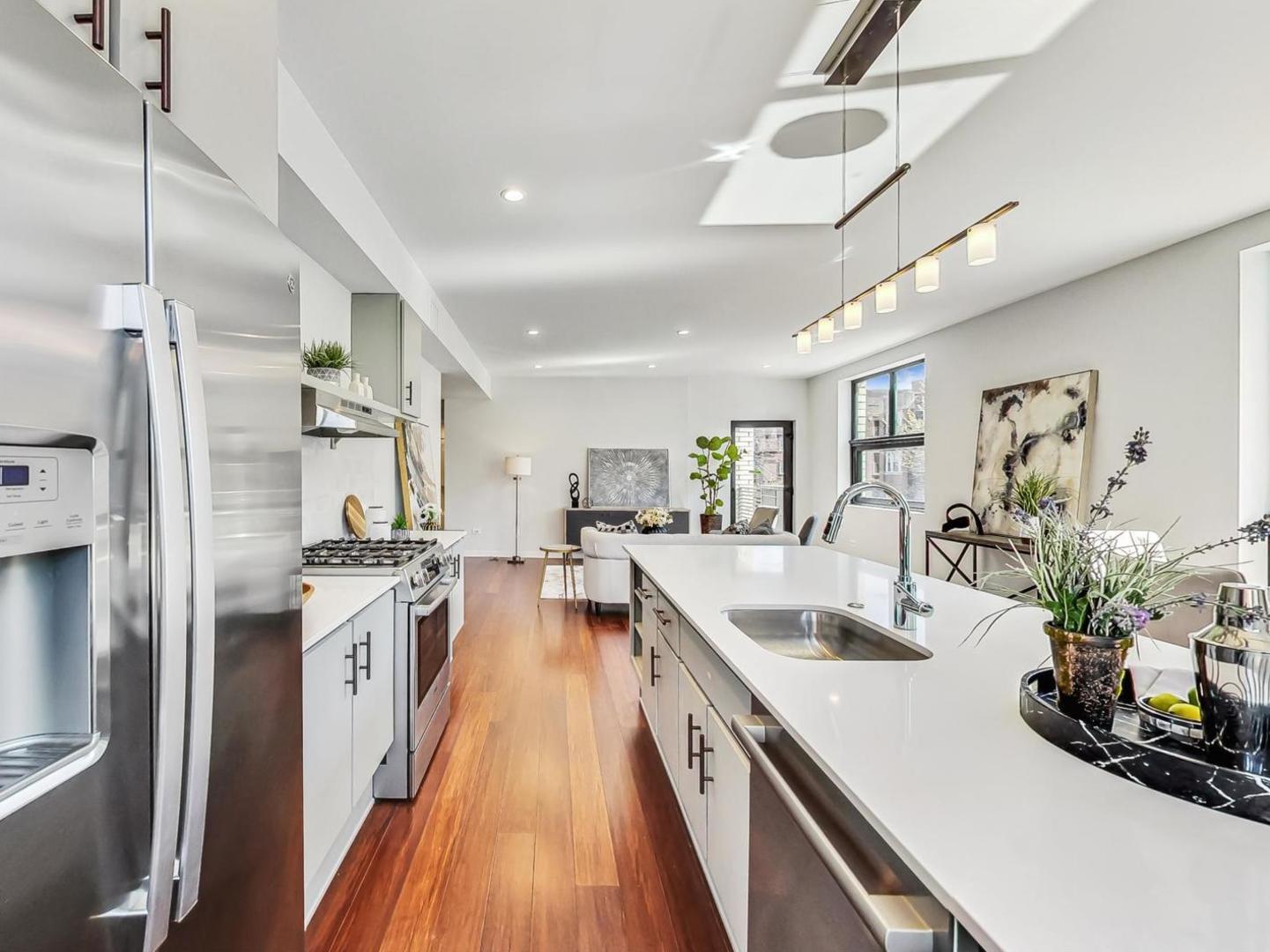 5691 North Ridge Avenue, Unit 201 Chicago, IL 60660 - Photo 7 of 31 a kitchen with stainless steel appliances a stove a sink a refrigerator and cabinets
