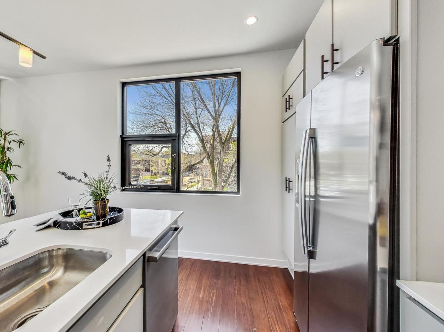5691 North Ridge Avenue, Unit 201 Chicago, IL 60660 - Photo 9 of 31 a kitchen with a refrigerator and a sink