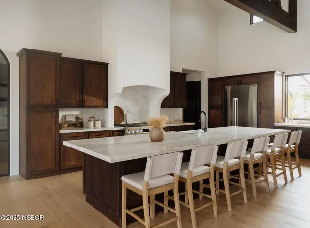 a kitchen with a dining table chairs and white cabinets