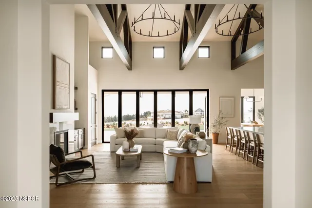 a living room with fireplace furniture and a large window