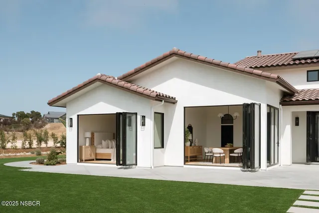 a view of a house with sitting area and garden