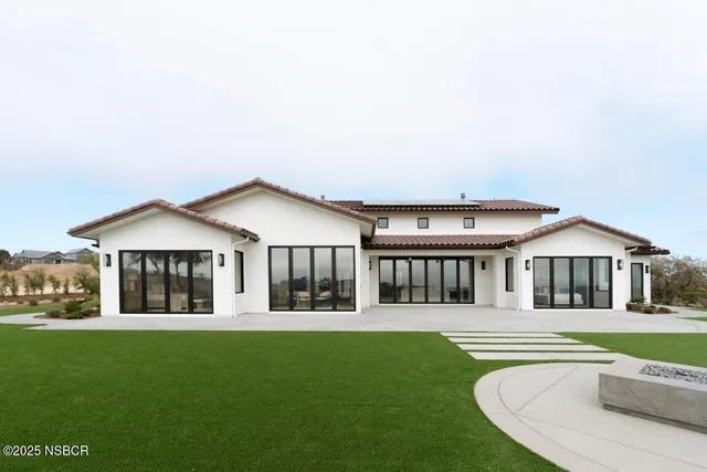 a front view of a house with a yard and porch
