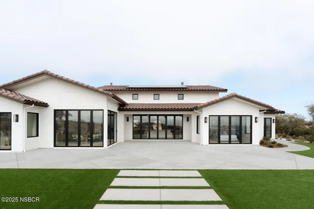 a front view of a house with a garden and porch