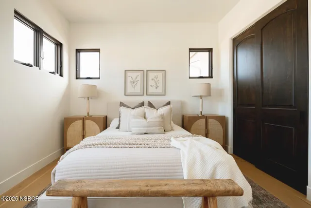 a bedroom with a bed and painting on the wall
