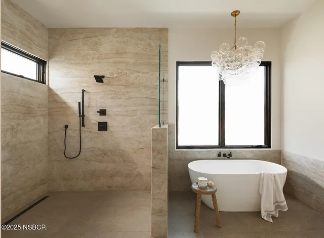 a bathroom with a bathtub and a shower