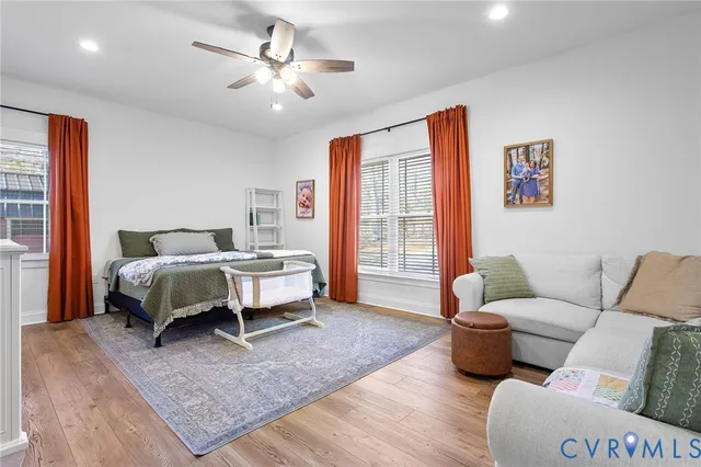 a bedroom with furniture and a large window