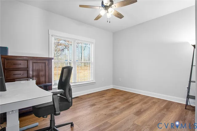 a view of a workspace with furniture and a window
